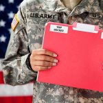 Top Army Boss Walks Amid Fued Soldier holding a red folder labeled top secret