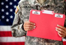 Top Army Boss Walks Amid Fued Soldier holding a red folder labeled top secret