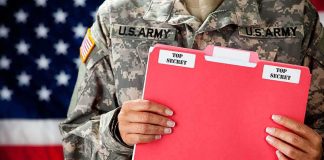 Top Army Boss Walks Amid Fued Soldier holding a red folder labeled top secret