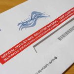 Courts Freeze USPS’s New Ballot Gate Mail-in ballot envelope with red label on wooden table