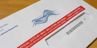 Courts Freeze USPS’s New Ballot Gate Mail-in ballot envelope with red label on wooden table