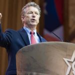 Rand Paul Drops ‘Pardon’ Bombshell On Fauci Man in suit speaking at a podium with a microphone