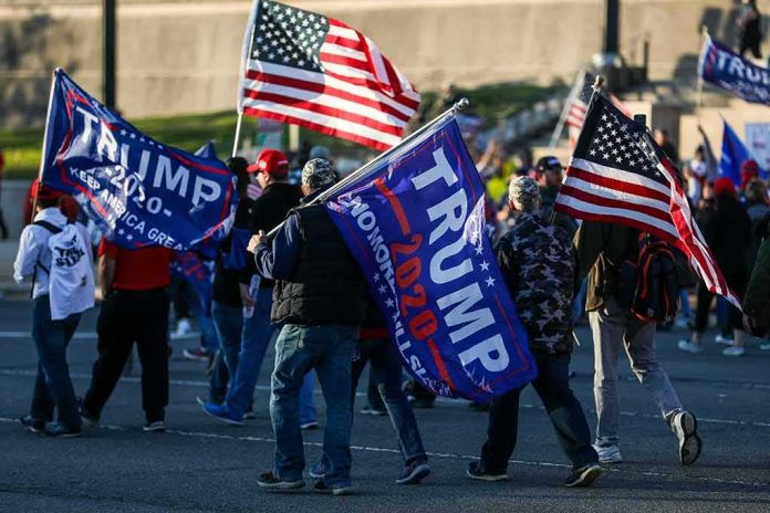 shutterstock_1855820569 Crowd of people carrying political and American flags at a street gathering