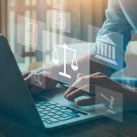 Minnesota’s Nudification Ban Capable of Punishing People Person typing on laptop with legal icons overlay