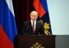 Did the CIA Tried to Assassinate Putin? speaker at podium with flags in background