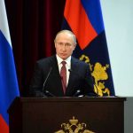 Did the CIA Tried to Assassinate Putin? speaker at podium with flags in background