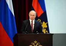 Did the CIA Tried to Assassinate Putin? speaker at podium with flags in background