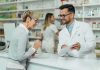 Healthcare Shock: 2026 Premiums Surge Pharmacist assists customer at pharmacy counter