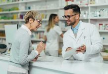Healthcare Shock: 2026 Premiums Surge Pharmacist assists customer at pharmacy counter