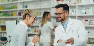 Healthcare Shock: 2026 Premiums Surge Pharmacist assists customer at pharmacy counter