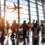 Dolly Parton Airport Push Shakes Nashville Passengers queue inside an airport terminal at sunset
