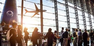 Dolly Parton Airport Push Shakes Nashville Passengers queue inside an airport terminal at sunset