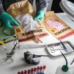 Beer Can Nails 1981 Murder Forensic technician handling evidence bags on a lab table