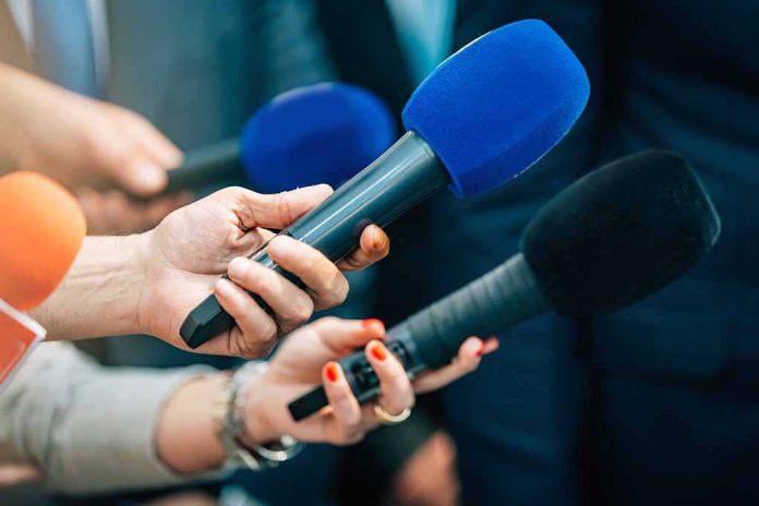 shutterstock_2168392339-6 Reporters holding colorful microphones
