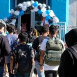 California Teachers Launch ‘ICE Patrols’ Around Schools Students with backpacks enter a school under a balloon arch