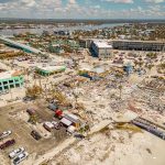 Deadly 7.7 Quake Rocks Indonesia as Aftershocks Keep Coming Aerial view of coastal town with widespread storm damage