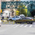 Inheritance Feud Turns Deadly Police cars block a city intersection with yellow crime scene tape