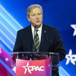 Rubio Surge Rattles GOP – Vance on Edge John Neely Kennedy speaking at a podium on a CPAC stage