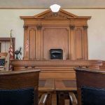 Would-Be Assassin Walks — Judge’s Sentence 22 Years TOO LOW Judge's bench in a traditional courtroom with wooden paneling and empty seats