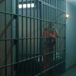Whistleblower Photos: ICE Detainees Extreme Overcrowding, Overflowing Toilets prison cell with inmates in orange jumpsuits behind bars