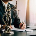 Women’s Sports Will Never Be The Same Lady Justice statue on a lawyer’s desk