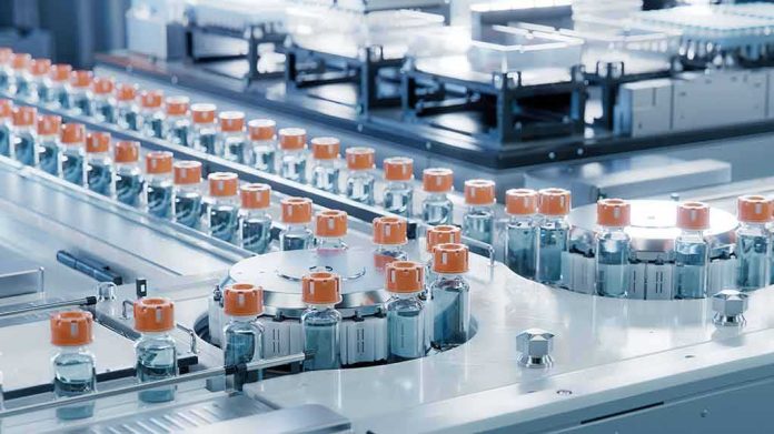 shutterstock_2422913535-1 Pharmaceutical vials on an automated production line