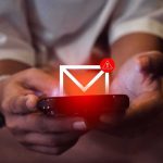 FBI Grabs Signal Previews Without Decrypting Hands holding a smartphone with an email alert icon glowing on screen