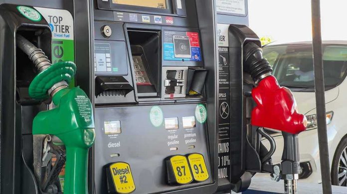 shutterstock_2493533293 Gas pump with green diesel and red gasoline nozzles