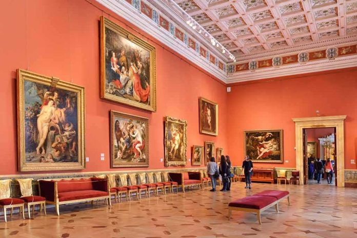 shutterstock_250876990 Art gallery room with large classical paintings on red walls