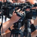Ancient Poem Uncovered: Hides in Plain Sight! television cameras on tripods at a media event