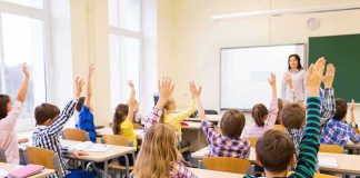 T-Shirt Battle Rewrites Classroom Free Speech Students raise hands in a classroom while a teacher stands at the front