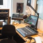 Dead Radio Host, New Episodes — What’s Going On? Radio studio with mixing console and microphone