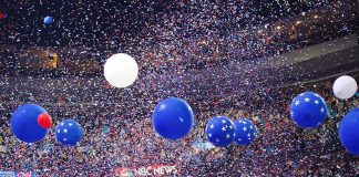Republicans Open First-Ever Midterm Convention in Dallas Blue and white balloons with confetti falling over a crowded indoor arena