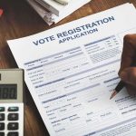 Voter Roll Shock: Thousands Of Illegals Flagged Person filling out a voter registration application form