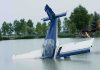 SICK! See How This Reporter Treated Tom Tiffany’s Plane Crash A submerged airplane partially in a lake with trees in the background