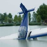 SICK! See How This Reporter Treated Tom Tiffany’s Plane Crash A submerged airplane partially in a lake with trees in the background