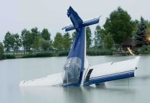 SICK! See How This Reporter Treated Tom Tiffany’s Plane Crash A submerged airplane partially in a lake with trees in the background