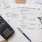Trump Targets Big Oil Utility bills with calculator, pen, and eyeglasses on a desk