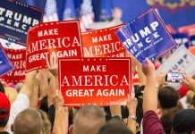 N-Word Bomb Dropped By Former GOP Advisor Crowd holding red and blue campaign signs at a political rally