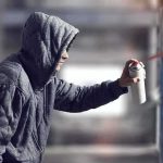Macklemore Painted in Gaza After Tour Removal Person in hoodie spray painting a wall