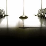 DOJ Pulls Plug On Canada Cooperation empty conference room with long table and chairs