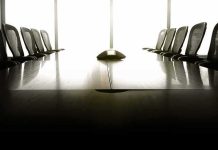 DOJ Pulls Plug On Canada Cooperation empty conference room with long table and chairs
