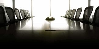 DOJ Pulls Plug On Canada Cooperation empty conference room with long table and chairs