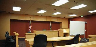 CBS Host Just Got Blindsided by the Clancy Jury Holdout Man Interior view of an empty courtroom with wooden furniture and American flags