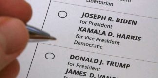 2 Dan Sullivans on the Same Senate BALLOT Hand holding pen near presidential election ballot.