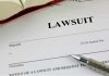 NYC Says Law Firm FAKED Slip-and-Fall Claims Lawsuit document with a pen and book.