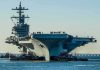 TOILET Failures Sideline Navy’s Priciest Carrier Aircraft carrier guided by tugboats in a harbor