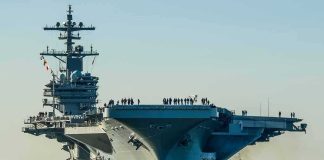 TOILET Failures Sideline Navy’s Priciest Carrier Aircraft carrier guided by tugboats in a harbor