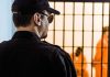 Man Convicted in Tupac MURDER Faces Sentencing Security guard watching inmates behind jail bars
