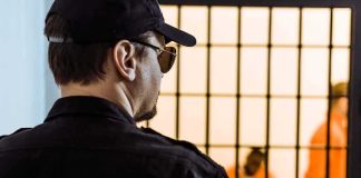 Man Convicted in Tupac MURDER Faces Sentencing Security guard watching inmates behind jail bars